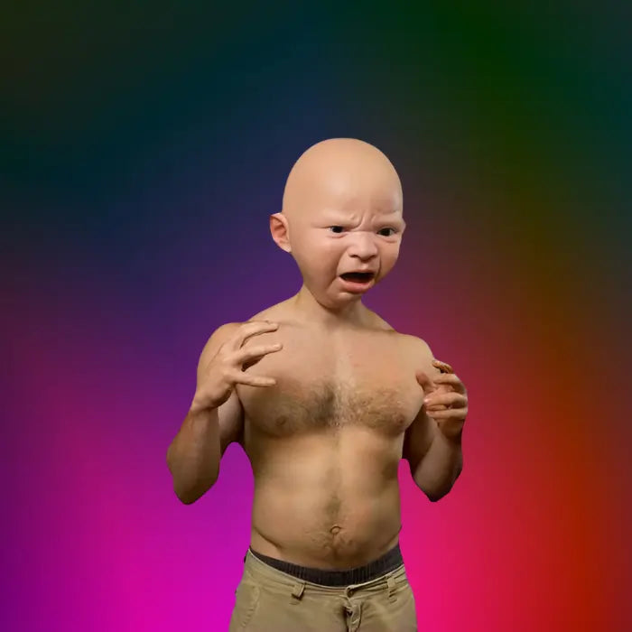 Shirtless man flexing muscles while wearing funny baby mask with furious expression and clenched hands.