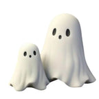 Funny ghost decoration featuring two white ghost figurines with surprised faces on plain white background.