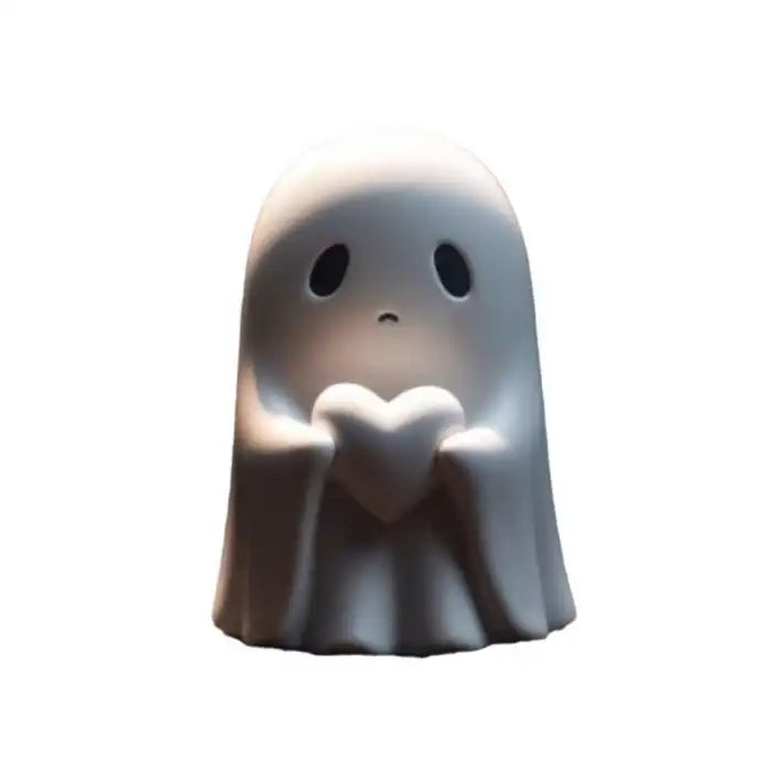Funny ghost decoration holding heart with sad eyes isolated on white background for product display.