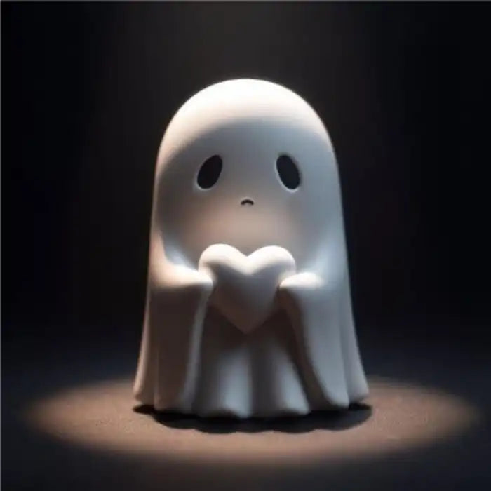 Funny ghost decoration with a sad face holding heart under spotlight in dramatic low lighting.