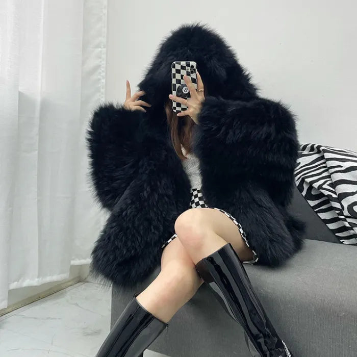 fur hooded coat in rich black featuring plush faux fur texture and modern oversized shape for a bold, warm winter fashion look
