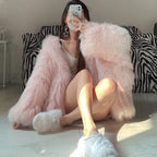 pink fur hooded coat with ultra soft faux fur texture, oversized sleeves and warm cozy feel creating a chic winter fashion moment
