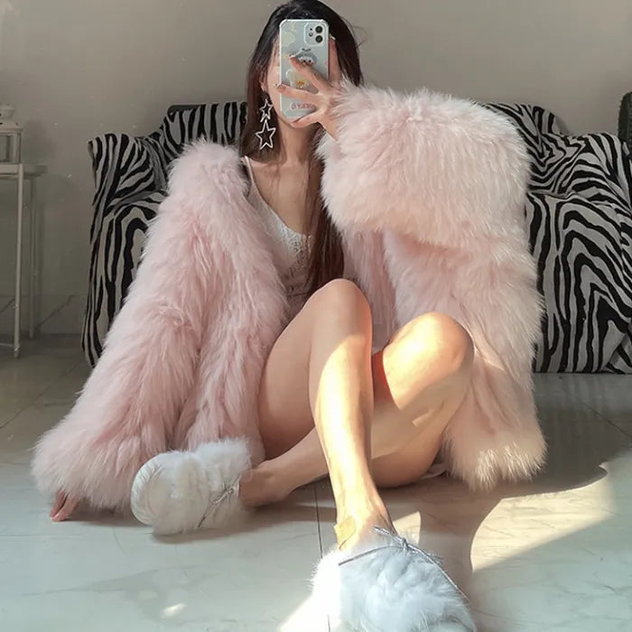 pink fur hooded coat with ultra soft faux fur texture, oversized sleeves and warm cozy feel creating a chic winter fashion moment