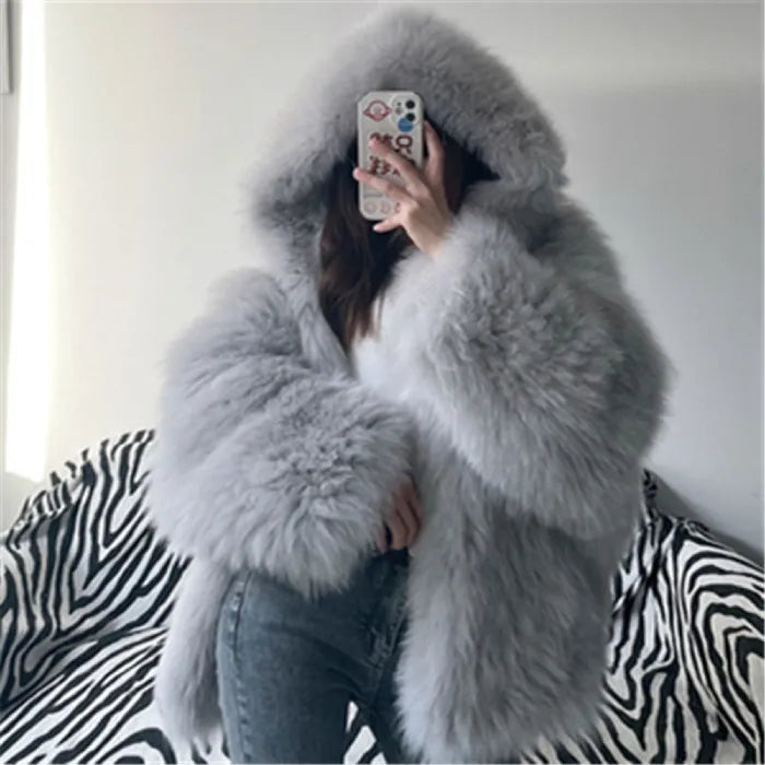 fur hooded coat in premium grey with oversized fluffy texture, ultra soft faux fur jacket look creating a cozy winter style vibe