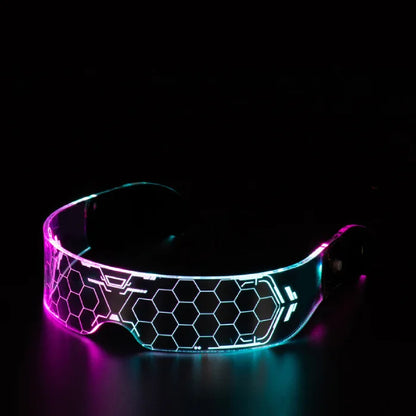 LED glasses glowing in pink and blue with a hexagonal futuristic design in a dark setting.