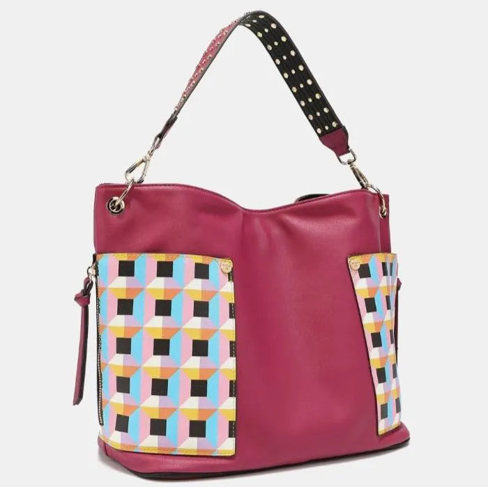Stylish pink leather hobo bag with geometric pastel pattern panels, studded strap, and silver hardware for modern fashion accessories