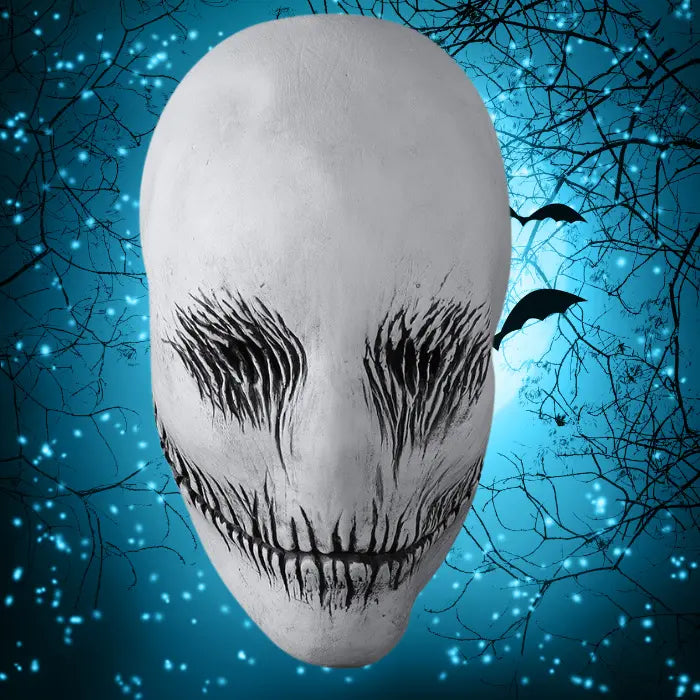 Ghost latex mask with black features shown against eerie blue forest background with bats and glowing lights.