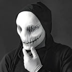 Ghost latex mask worn with hooded costume and gloves, featuring sinister black stitched design.