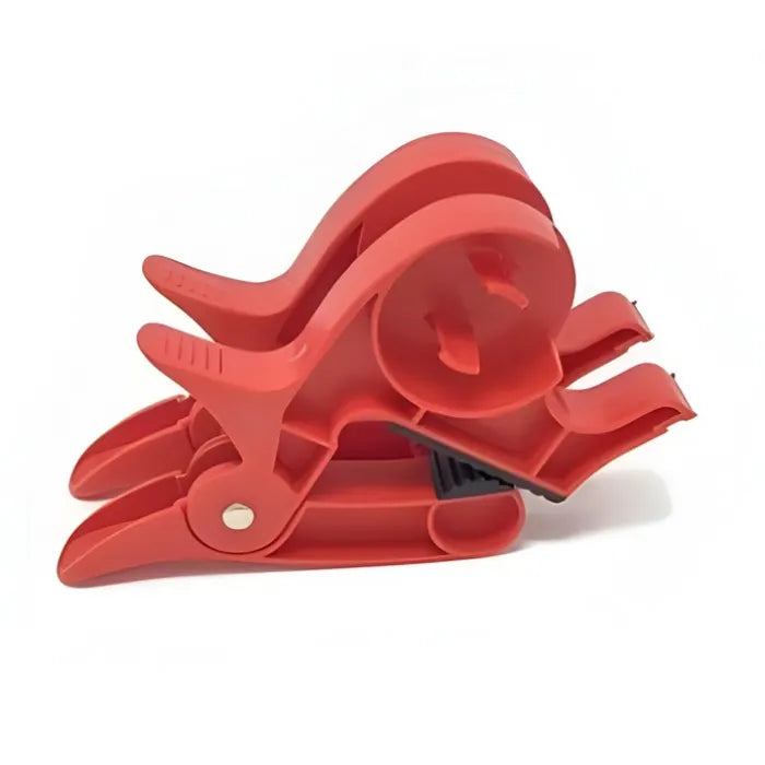 Gift wrapping clamps in red displayed in folded position, providing strong grip and smooth paper handling for fast, organized gift wrapping.