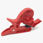 Gift wrapping clamps in lightweight red design shown ready for tape attachment, ideal for smooth gift-wrapping and paper control.