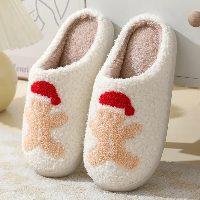 Fluffy Christmas slippers with a gingerbread man wearing a red Santa hat.