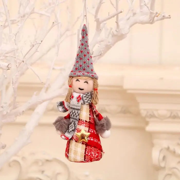 Girl gnome Christmas ornament with blonde hair, tall knitted hat, and red plaid outfit hanging on white tree branch