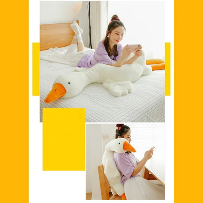 Young girl using a large duck plush as a pillow while in bed.