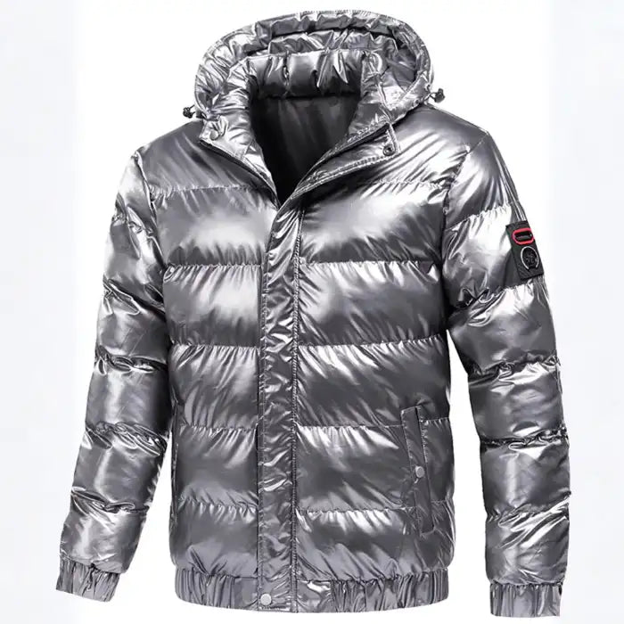 Glossy quilted puffer jacket with hood in metallic silver, featuring zip front, elastic cuffs, and ribbed waistband.
