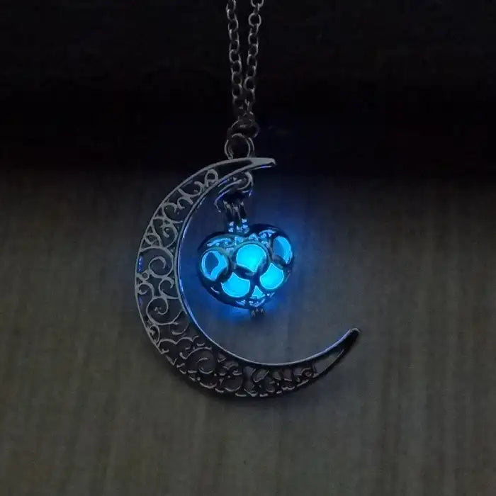 Glowing necklace with crescent moon frame and vibrant blue heart-shaped glowing charm.