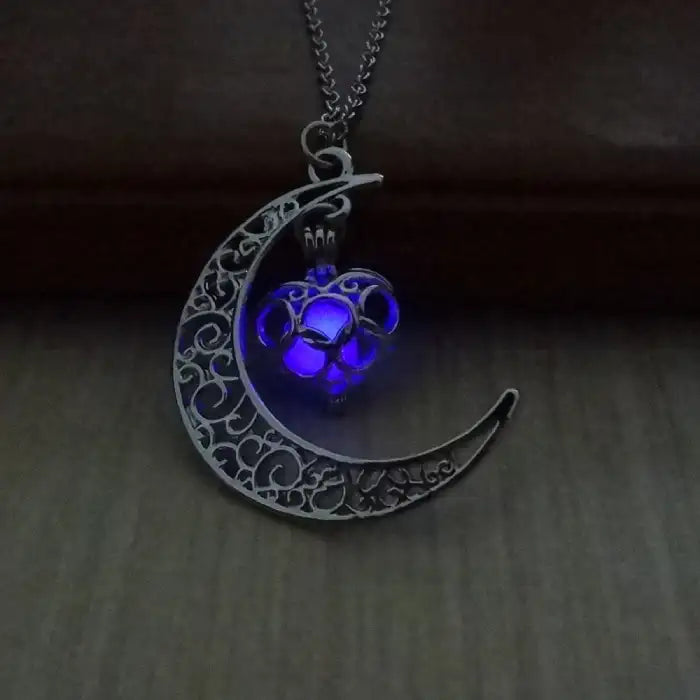 Glowing necklace with detailed silver moon and vivid purple glowing heart pendant on chain.