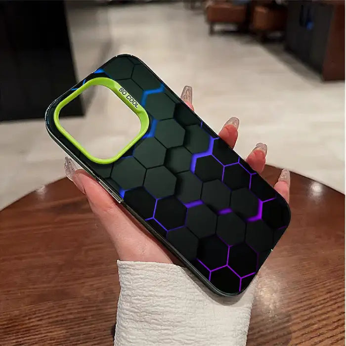 Glowing protective iPhone case featuring black hexagon pattern with blue-purple illuminated edges and neon green camera frame