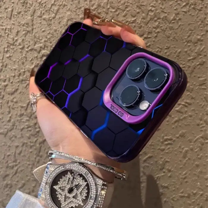 Glowing protective iPhone case featuring black hexagonal pattern with purple-blue illuminated edges and purple camera border