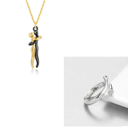 Gold and black couple embrace pendant necklace combined with a silver hand design ring for unique style.