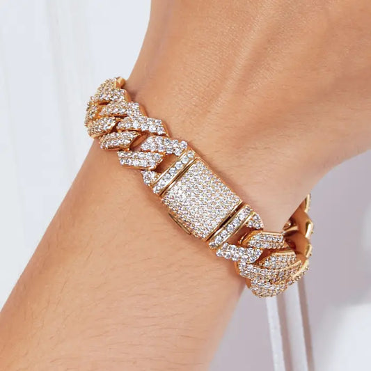 Gold Cuban link bracelet with sparkling diamonds, featuring a secure clasp for luxury fashion wear.