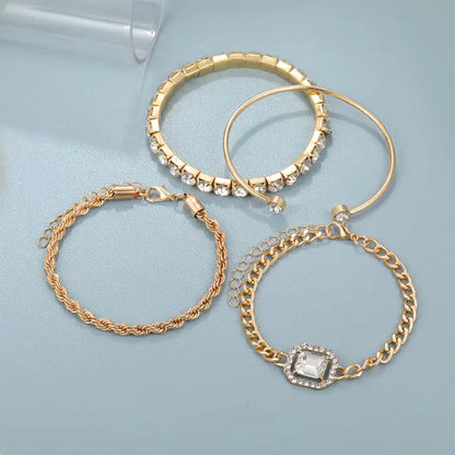 Flat display of gold bracelet set featuring crystal accents and various chain styles for elegant occasions.