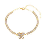 Gold butterfly chain anklet with sparkling crystals and adjustable clasp displayed on a white background.