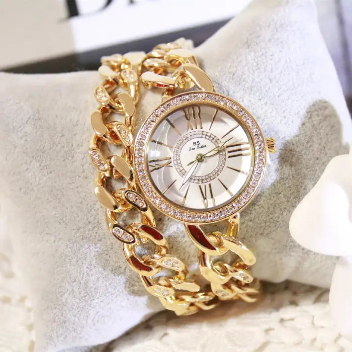 Classic gold chain watch with Roman numeral dial and crystal embellishments for women's luxury style.