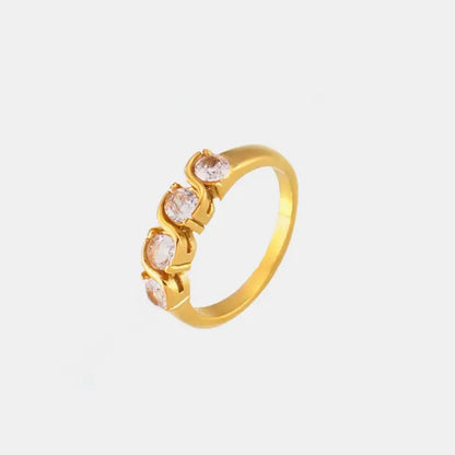 Gold ring with a twist design set with cubic zirconia stones, on a white background.