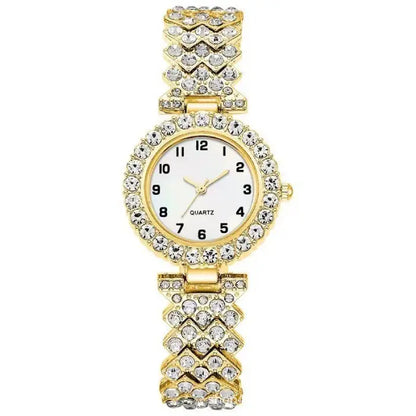 Gold quartz wristwatch with a white face and diamond like-studded band in a chevron design.