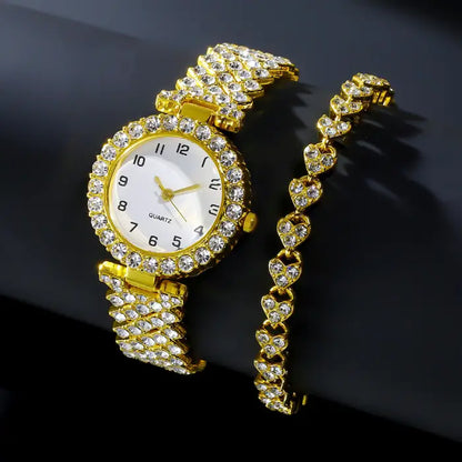 Gold diamond like-studded quartz wristwatch paired with a matching heart-design bracelet on a black background.
