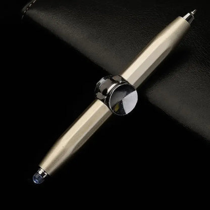 Gold fidget spinner pen with dual stylus tips placed on a black leather background.