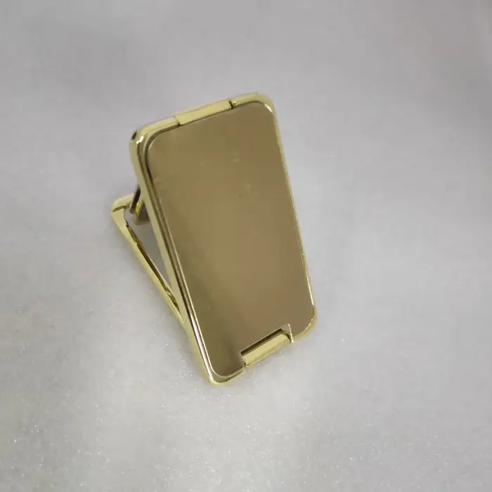 Gold foldable phone stand offering portable, adjustable support for smartphones and ergonomic design.