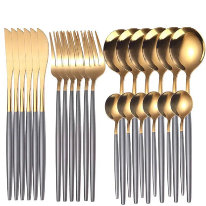  Modern flatware set featuring gold-topped utensils with grey handles, including knives, forks, and spoons on white background