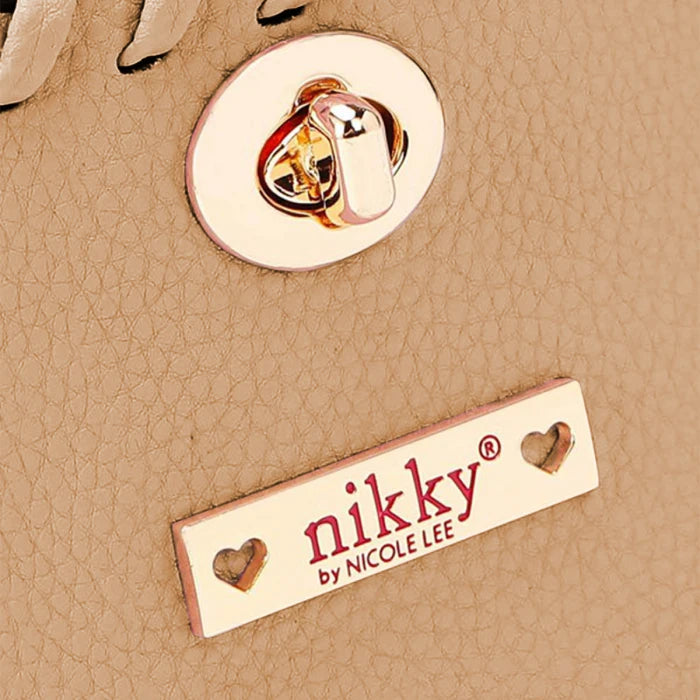 Close-up of gold-tone hardware and Nikky by Nicole Lee branded nameplate with decorative heart details