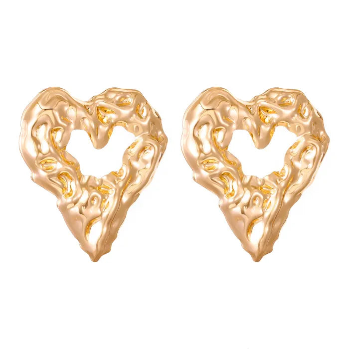 Gold heart Earrings bold textured gold heart stud pair on white background