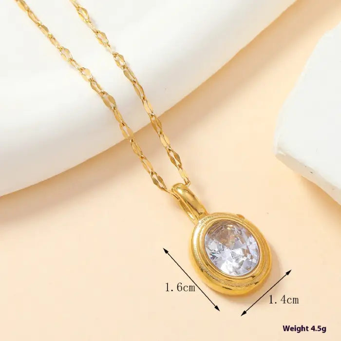 Gold oval clear stone pendant necklace with delicate chain, a refined choice for classic jewelry.