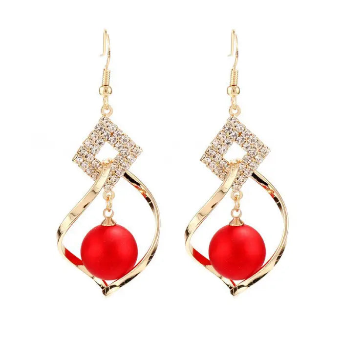 Elegant gold dangle earrings with sparkling crystals and red beads for women’s fashion accessories.