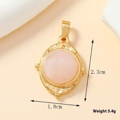 Gold round pink stone pendant with textured edges, shown with dimensions for jewelry enthusiasts.