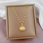 gold seashell necklace with crystal shell pendant displayed in box with elegant chain presentation