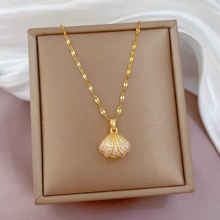 gold seashell necklace with crystal shell pendant displayed in box with elegant chain presentation
