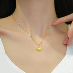 gold seashell necklace with sparkling shell pendant worn on model showcasing elegant chain and design