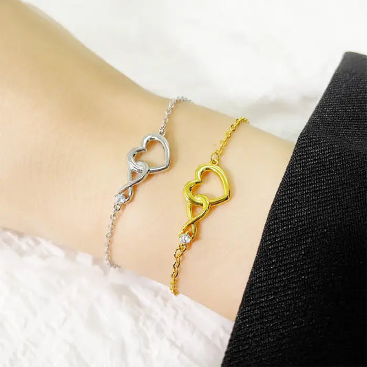 Dual gold and silver heart infinity bracelets for women, elegant design with delicate chain details.