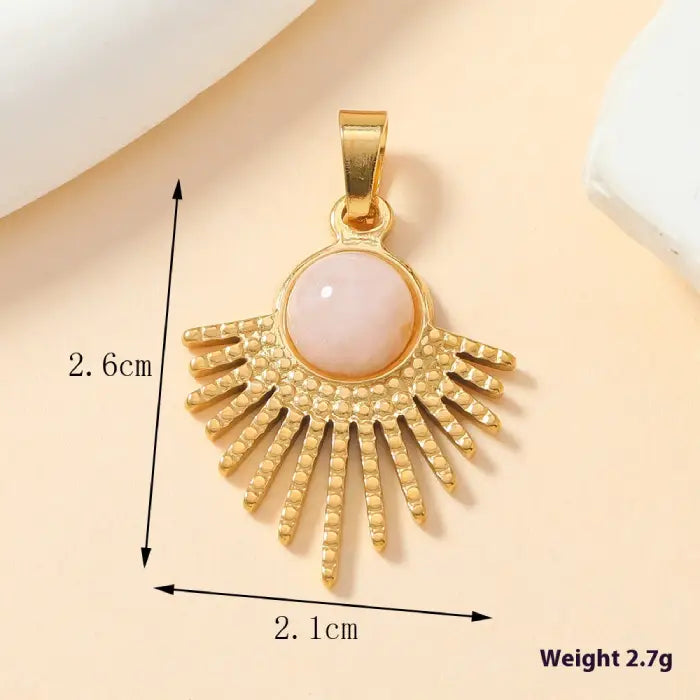 Gold sunburst pendant with pink opal stone centerpiece, a bold and trendy accessory for fashion lovers.