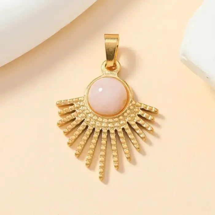 Gold sunburst pendant with pink round opal stone centerpiece, perfect for boho chic fashion jewelry lovers.