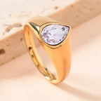 gold teardrop birthstone ring with a lilac gemstone offering soft sparkle in a smooth gold band, shown in bright close-up product view