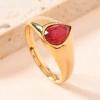 gold teardrop birthstone ring with deep red gemstone shown with size measurements, highlighting stone dimensions and gold finish