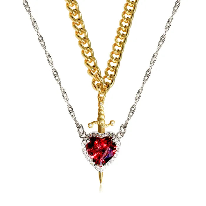 Gothic Heart Necklace combining gold and silver chains with striking red heart gemstone and dagger detail.