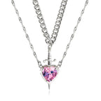 Gothic Heart Necklace featuring pink crystal heart with layered silver chains and dagger detail.