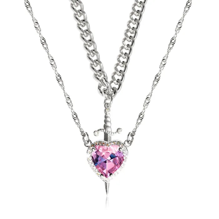 Gothic Heart Necklace featuring pink crystal heart with layered silver chains and dagger detail.
