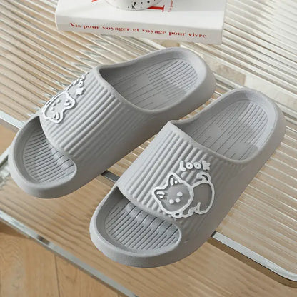 Light gray bathroom slides with white cartoon cat design displayed against striped background